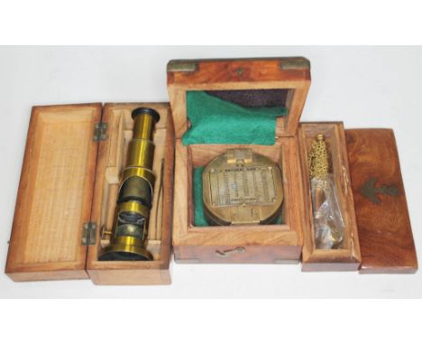 Three cased instruments to include a reproduction military compass, a reproduction boatswain's whistle and a small brass micr