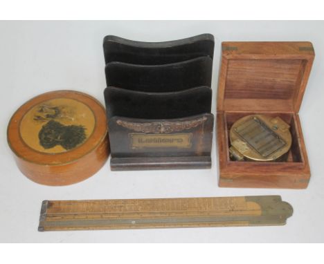 A mixed lot comprising a reproduction brass compass in wooden case, a wooden letter rack, a circular wooden box with doggy po