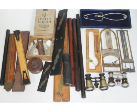 A collection of instruments including rulers, a student's microscope, barometers, together with two pairs of vintage opera gl