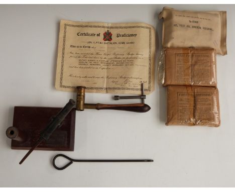 Desk top pen holder with a swivel gun adornment, shot measuring tool, three first field dressings etc
