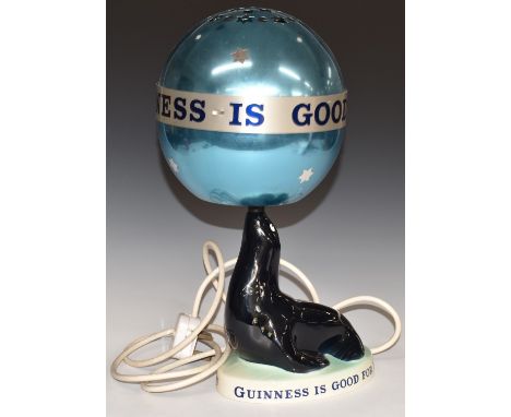 Carltonware 'Guinness is Good For You' figural sea lion convector lamp with revolving ball/shade, H37cm