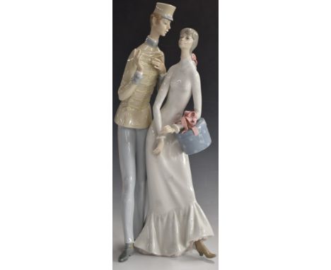 Lladro figure of a girl with a hatbox talking to a bellboy, H44cm