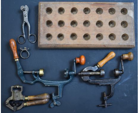 A collection of 12 bore shotgun re-loading and shooting accessories including cartridge extractor, cartridge sizing tool, car