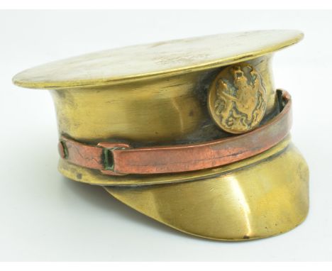 WW2 trench art officer's cap made from a brass shell, with copper chin strap and button badge, diameter 7.5cm&nbsp;