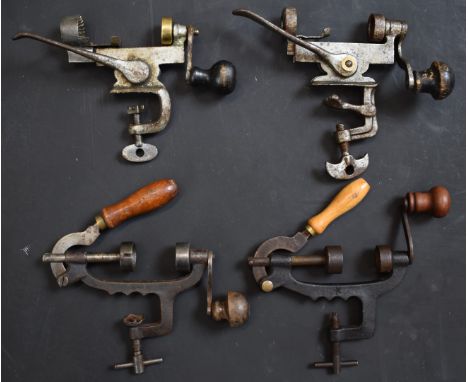 Four 12 bore shotgun cartridge rollover tools including one stamped 'AG'.&nbsp;