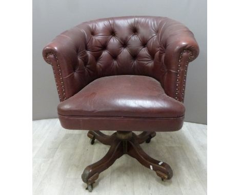 A vintage leather Chesterfield swivel / office chair with button back and wooden base, H87cm