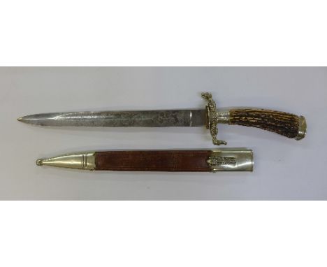 A hunting dagger with etched blade and scabbard