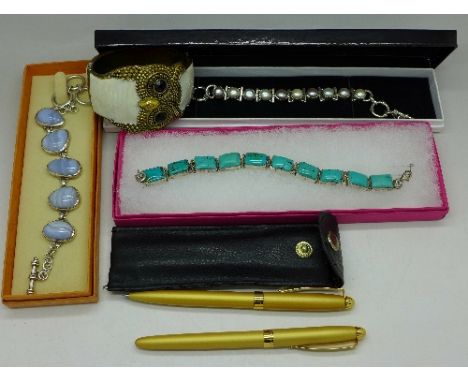 Silver and stone set jewellery, an owl bangle and a pen set