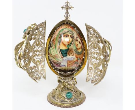 Ornate gilt Faberge style filigree egg with rotating wooden icon inside and turquoise cabochons, H: 17 cm. P&amp;P Group 2 (£
