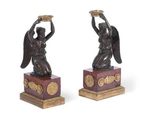 A PAIR OF FRENCH BRONZE FIGURAL MANTLE GARNITUREEARLY 19TH CENTURY modelled as kneeling angels on Rosso antique ormolu mounte