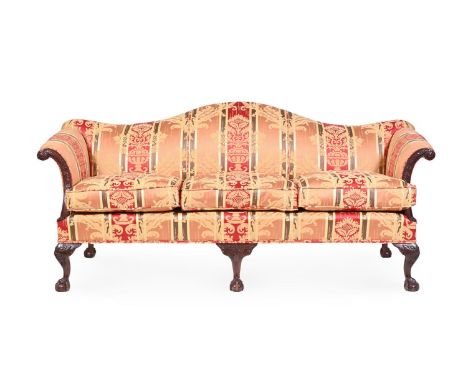 A CARVED WALNUT AND UPHOLSTERED SOFA IN GEORGE III STYLE, 20TH CENTURY  Of 'camelback' form  94cm, 210cm wide, 85cm deep over