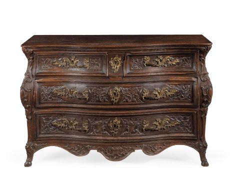 A LOUIS XV BOMBE OAK COMMODE THIRD QUARTER 18TH CENTURY, PROVINCIAL FRANCE  With two short and two long panelled drawers carv