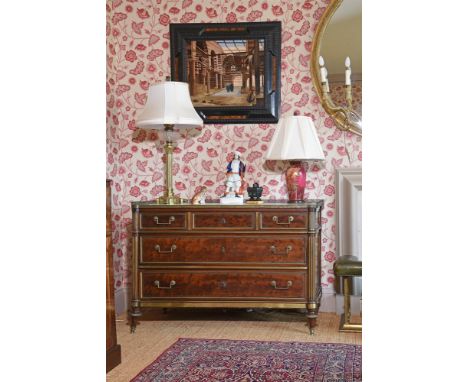 A DIRECTOIRE 'PLUM PUDDING' MAHOGANY AND GILT METAL MOUNTED COMMODE CIRCA 1795 With Carrara marble top 91cm high, 130cm wide,