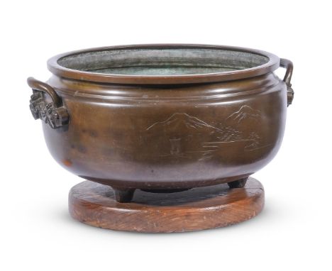 A JAPANESE BRONZE TWO HANDLED BOWL ENGRAVED WITH A MOUNTAINOUS LANDSCAPE FIRST QUARTER 20TH CENTURY28cm high, 53cm diameter 