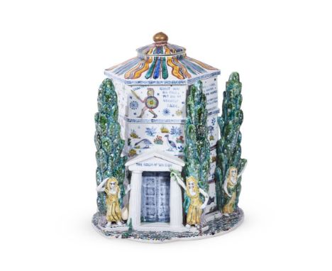 A POTTERY ARCHITECTURAL JAR AND COVER20TH CENTURY modelled as temple with cypress trees and figures inscribed 'The house of t