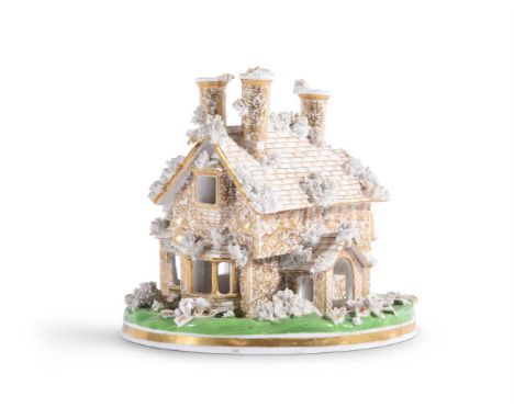 A STAFFORDSHIRE BONE CHINA MODEL OF A COTTAGE ORNÉ15cm highCondition Report: Small losses to green enamel and small nibbles t