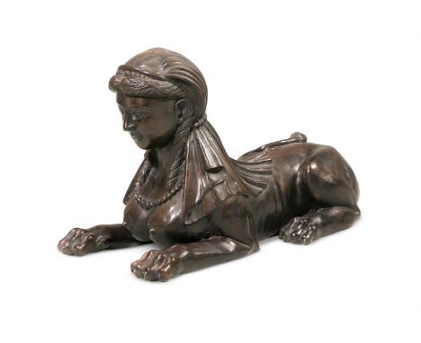 A BRONZED METAL MODEL OF A A RECUMBENT SPHINX LATE 20TH CENTURY 37cm high, 29cm deep, 60cm wide 