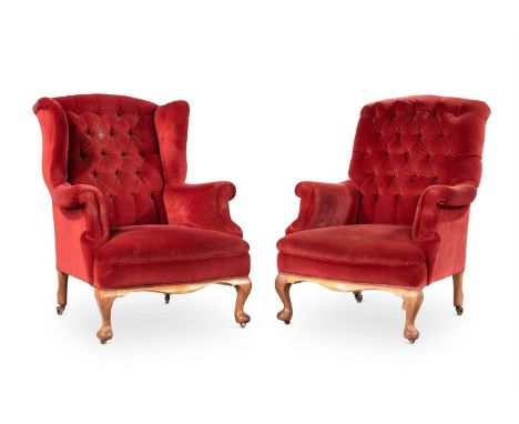 A COMPANION PAIR OF WALNUT AND BUTTON UPHOLSTERED ARMCHAIRS IN GEORGE II STYLE, MID 20TH CENTURY One with wing backeach appro