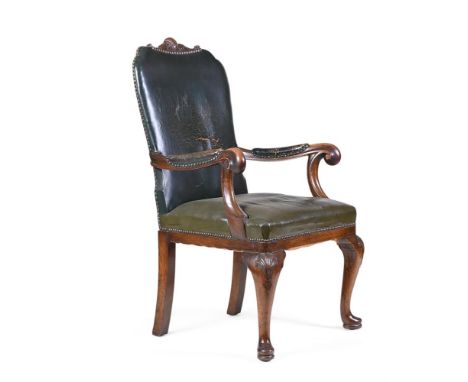 A LATE VICTORIAN OAK ARMCHAIRLATE 19TH CENTURY  Covered in green leather, with outscrolled arms and on cabriole legs headed b