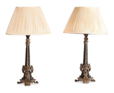 A PAIR OF EBONIZED AND GILT METAL MOUNTED LAMP BASESMODERNwith scrolling trefoil bases 22cm high (including shade)Condition R