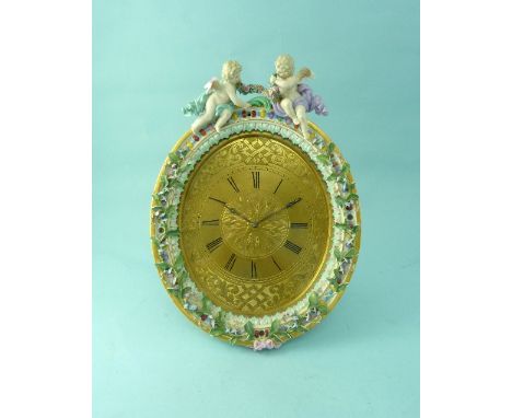 A late 19th Century Meissen porcelain framed oval strut Clock, the gilt metal dial with Roman numerals and engine turned scro