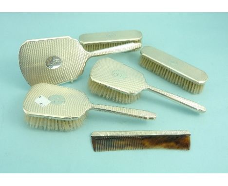 A cased six piece silver-backed Dressing Table set, hallmarked Birmingham, 1974, comprising, hand mirror, two hair brushes, c