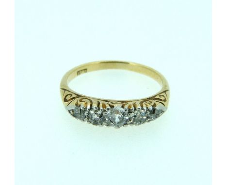 A seven stone graduated diamond Ring, with carved gallery and shank, in 18ct yellow gold, Size M.