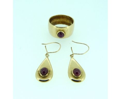 A wide 9ct yellow gold Ring, set with a cabochon ruby, 9g, together with a matching pair of pear shaped drop earrings each se