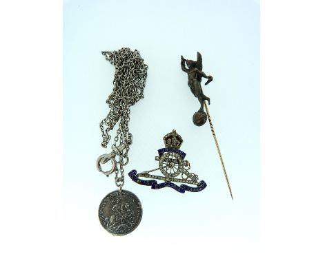 A Royal Artillery enamel and marcasite Brooch, together with a stick pin with a winged figure standing on a globe and a long 