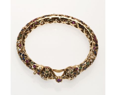 A Indian inspired yellow gold hinged Kundan set openwork Bangle, with flowerheads of rubies, emeralds, sapphires and pearls, 