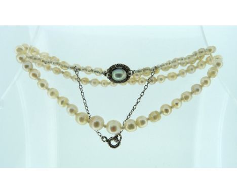 A small Necklace, made from graduated cultured and seed pearls on a diamond set and pearl clasp. 