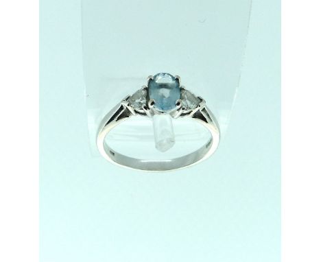 A oval aquamarine set Ring, with a heart shaped diamond on each shoulder, mounted in white gold marked 750, Size R.