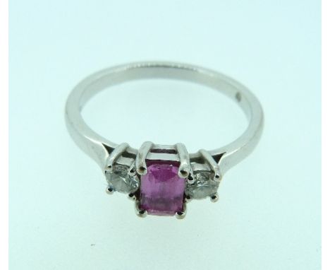 A step cut pink sapphire Ring, with a brilliant cut diamond on each shoulder, mounted in white gold marked 750, Size R.