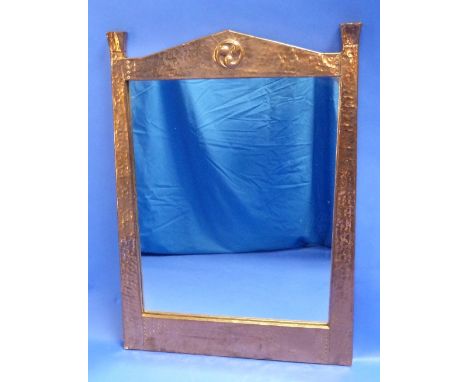 An Arts & Crafts copper wall Mirror, the upright rectangular plate within a hammered copper frame of architectural form with 