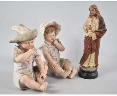 A Cold Painted Terracotta Figure of Standing Jesus Together with Two Bisque Porcelain Seated Babies in Bonnets, Jesus 26cm Hi