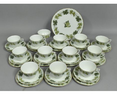 A Royal Worcester Tea Set to comprise Twelve Cups, Side Plates and Saucers together with a Cake Plate (One Cup AF) 