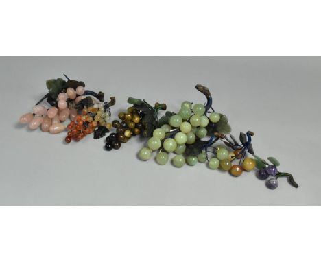 A Collection of Various Chinese Carved Stone and Jadeite Grapes and Berries, All with Jade Style Leaves 