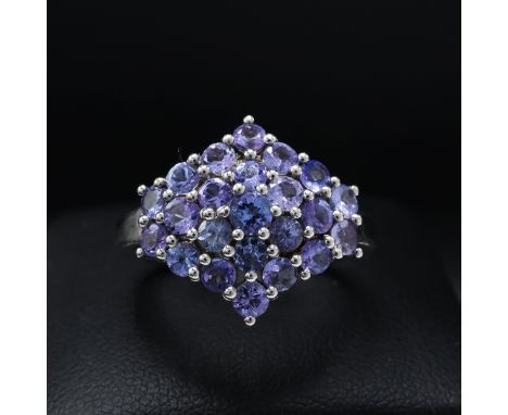 A 9CT GOLD TANZANITE CLUSTER RING, set with 19 round mixed cut tanzanites, ring size K½, together with a further tanzanite cl