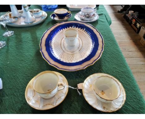 A Derby porcelain teacup and saucer, having gilt decoration on an ivory ground, together with a tea bowl and saucers in the s
