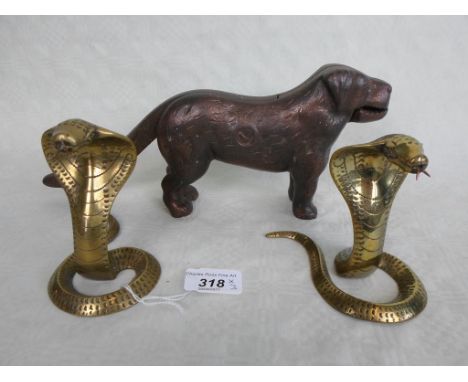 A pair of Indian brass Cobras (11cm), together with a nutcracker modelled as a dog.