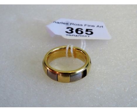 An 18ct yellow and white gold gentleman's ring, stamped 750.   Condition Report:  Stamped 'Jess James 750' and 'pgs pat. pend