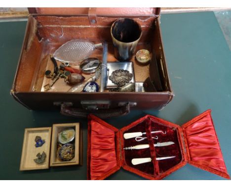 A small brown leather suitcase, containing assorted items to include: a horn beaker, white metal decanter labels, a banded ag