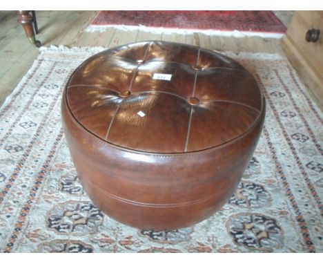 A leather circular pouffe (45cm diameter).
