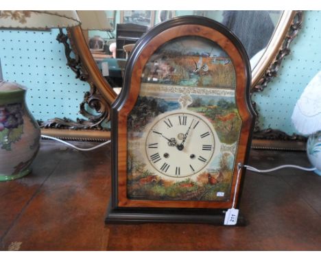A contemporary Franklin Mint mantle clock in the Georgian-style, having printed decoration to the face, the circular dial bea