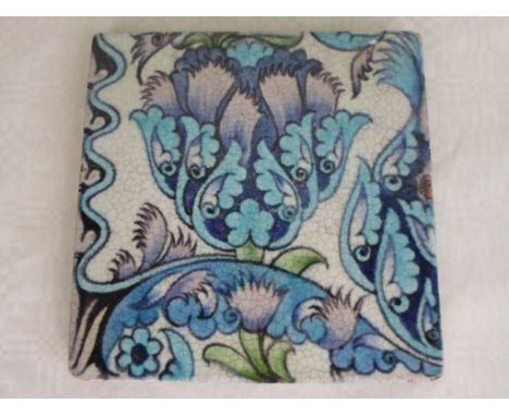 A William de Morgan tile of Islamic inspired design, painted in shades of green and blue, circular DM98, impressed mark to re