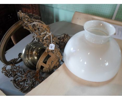 A gilt metal ceiling oil lamp, converted to electricity, having opaline shade.