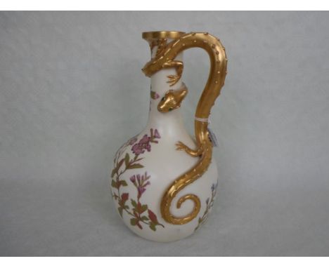 A late 19th century Royal Worcester bottle vase, having foliate decoration on an ivory ground, the gilded handle formed as a 