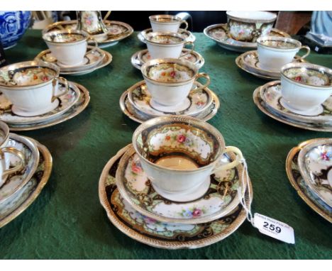 A Noritake part-tea service, comprising ten trios, two plates, an open sugar bowl and milk jug, having hand painted floral de