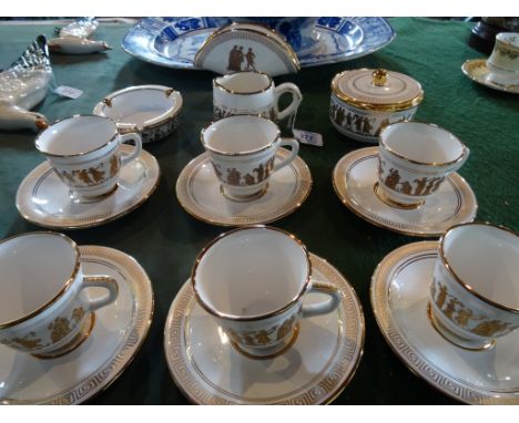 A 20th century part-tea service, decorated in 24ct gold leaf, signed 'Neofitou', comprising: six cups & saucers, covered suga