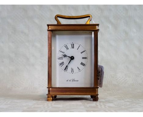 A gilt brass carriage clock, the five bevel edged glass panels enclosing a movement signed De La Grense, the enamel dial bear